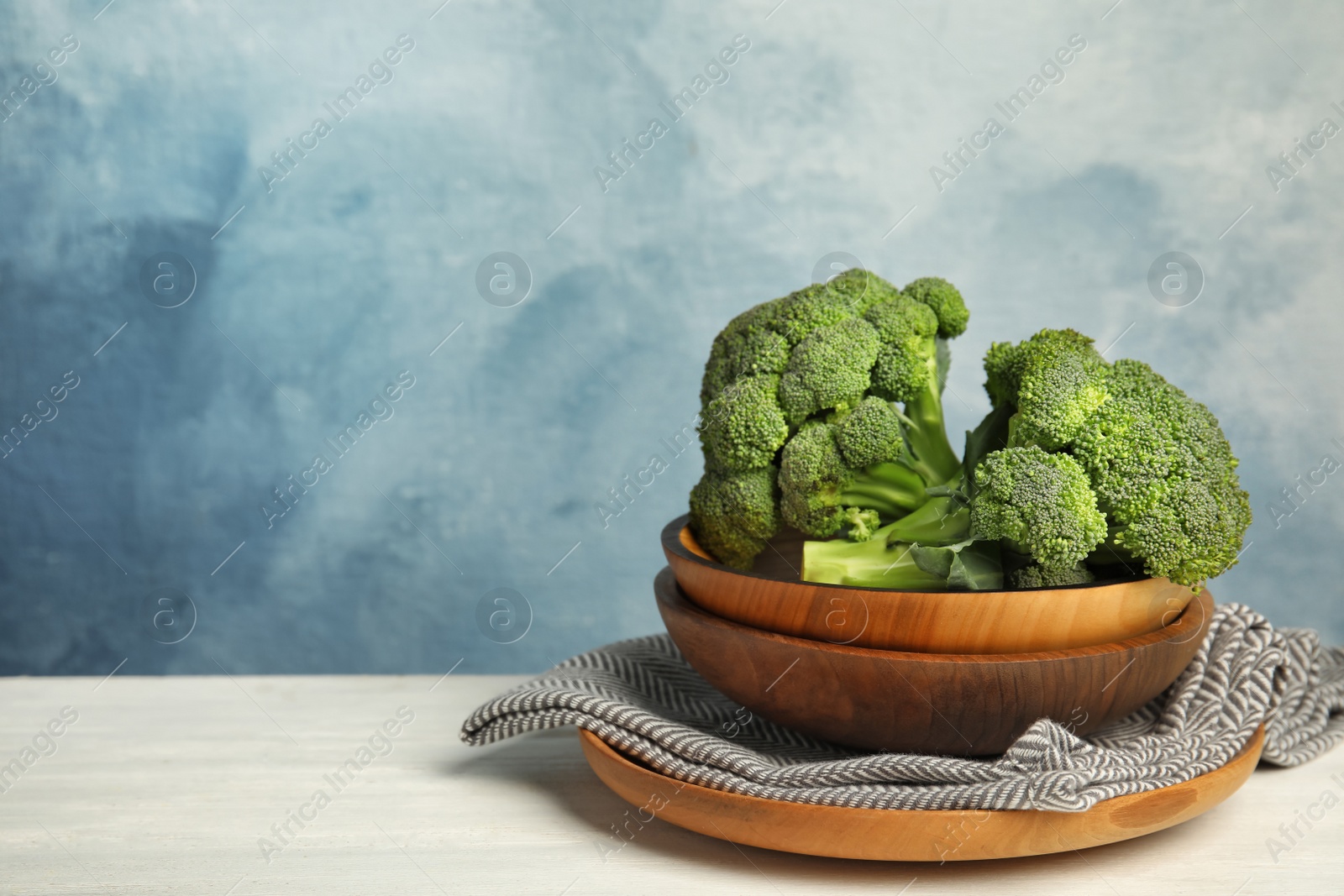 Photo of Plates with fresh broccoli on table. Types of cabbage