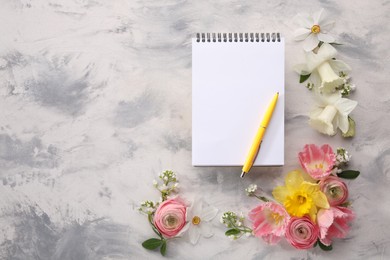 Photo of Guest list. Notebook, pen and beautiful flowers on gray textured background, flat lay. Space for text