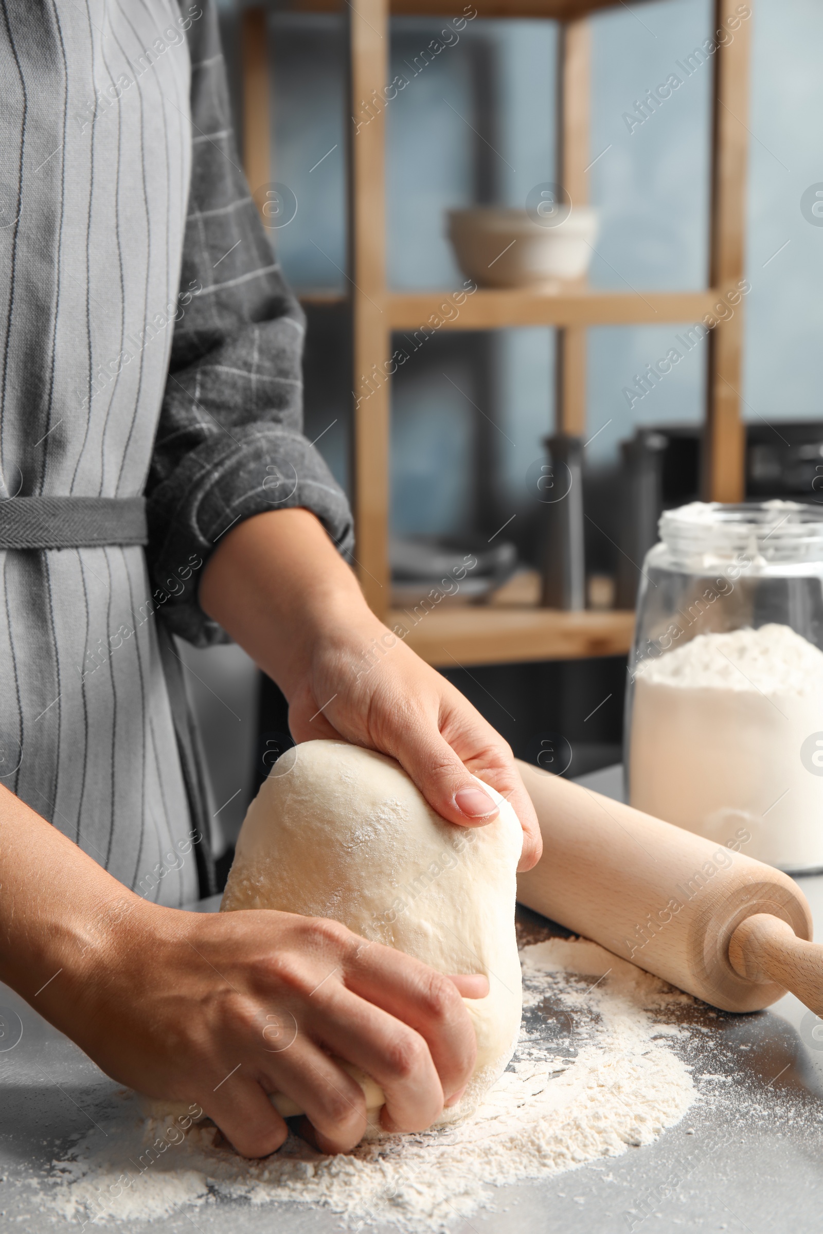 Photo of Woman kneading dough for pastry on table