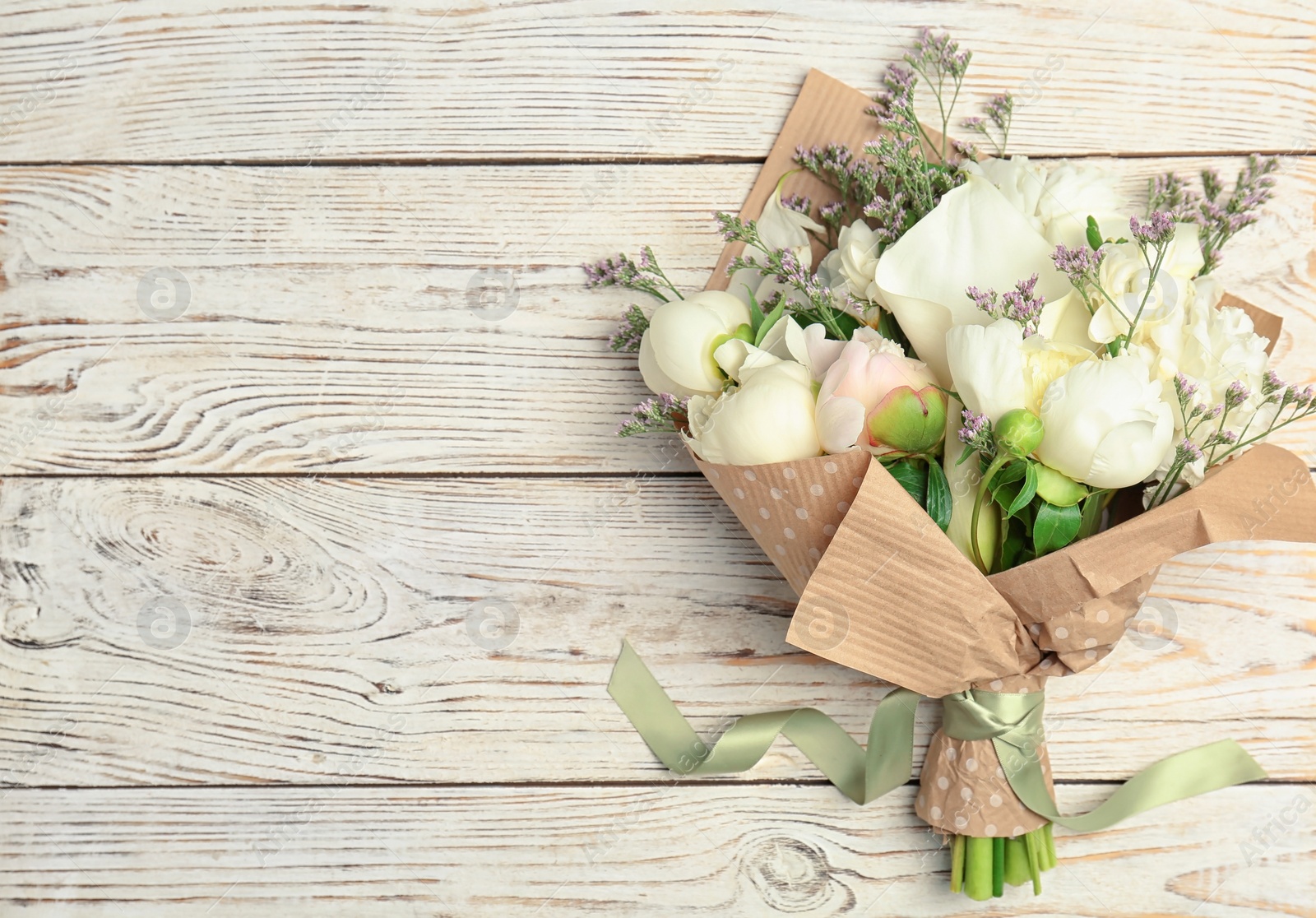 Photo of Bouquet of beautiful fragrant flowers on wooden background