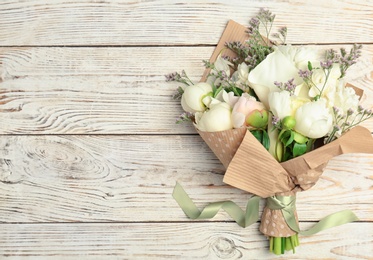 Photo of Bouquet of beautiful fragrant flowers on wooden background