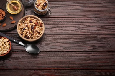 Tasty granola with nuts and dry fruits on wooden table, flat lay. Space for text