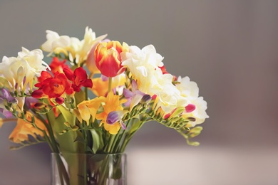 Photo of Beautiful bouquet of freesia flowers on blurred background