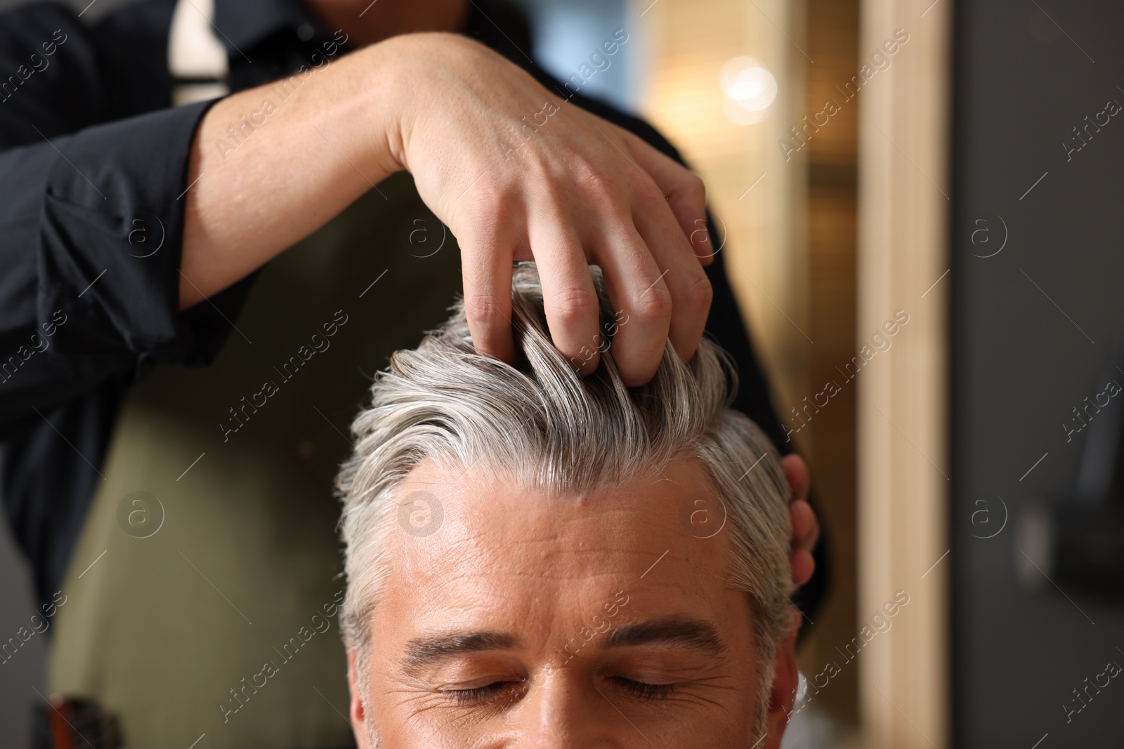 Photo of Hair styling. Professional hairdresser working with client in barbershop, closeup