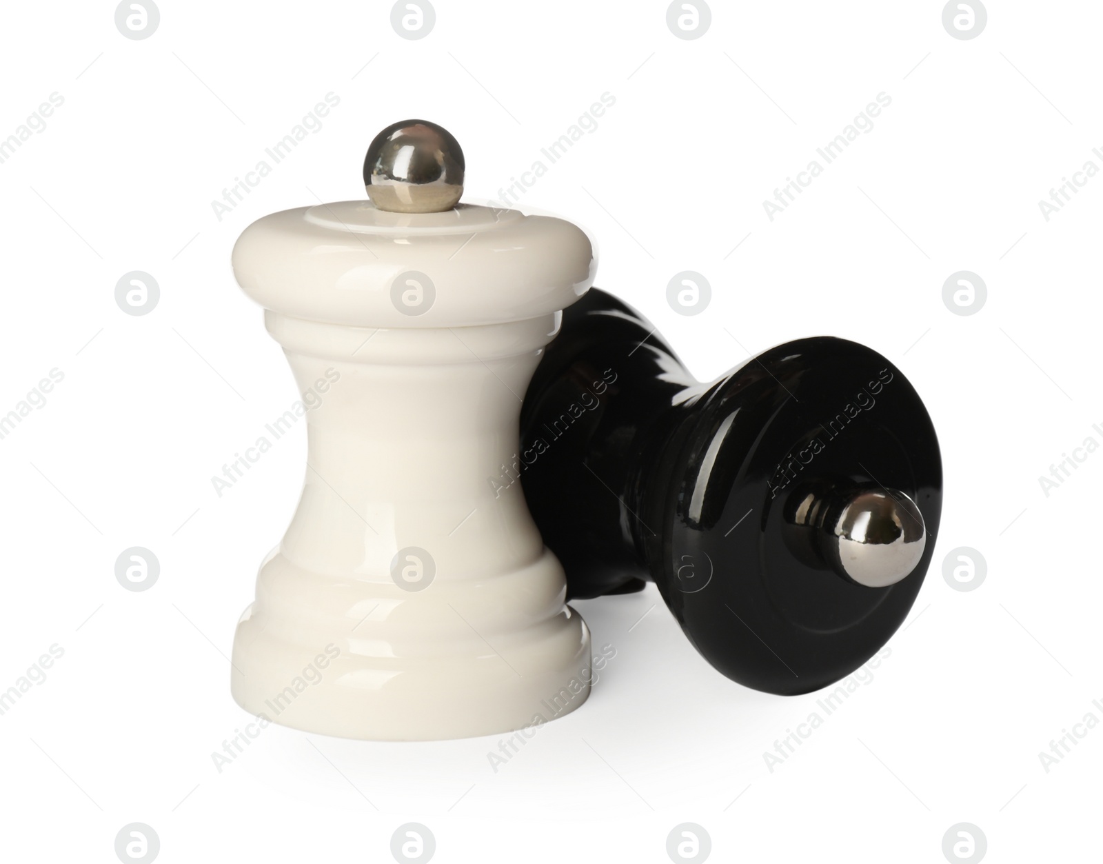 Photo of Wooden salt and pepper shakers isolated on white. Spice mill