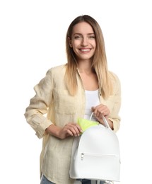 Photo of Happy young woman putting disposable menstrual pad into backpack on white background