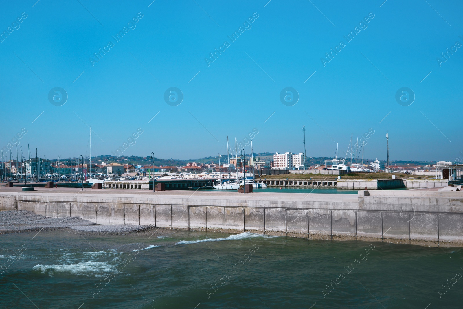 Photo of Beautiful view of city from pier with boats