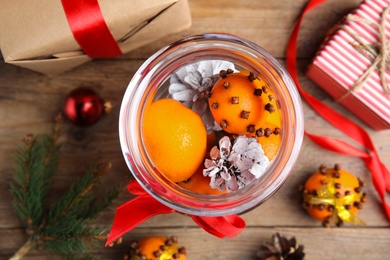 Flat lay composition with tangerine pomander balls on wooden table