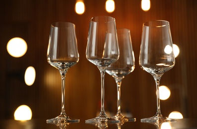 Empty wine glasses on table against blurred background