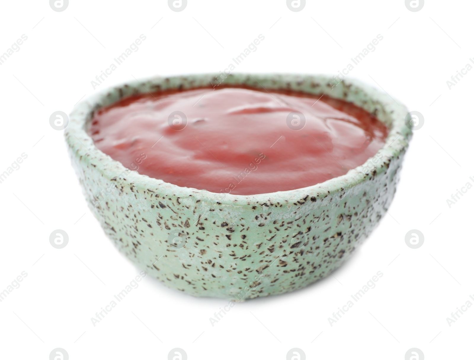 Photo of Bowl of spicy chili sauce on white background