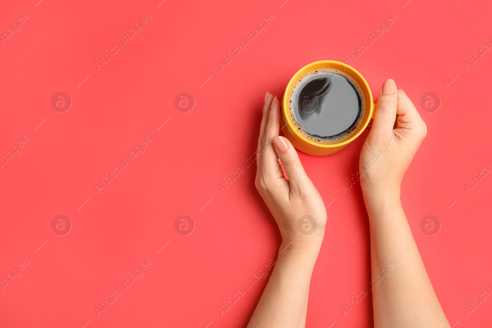 Photo of Woman with cup of coffee on red background, top view. Space for text