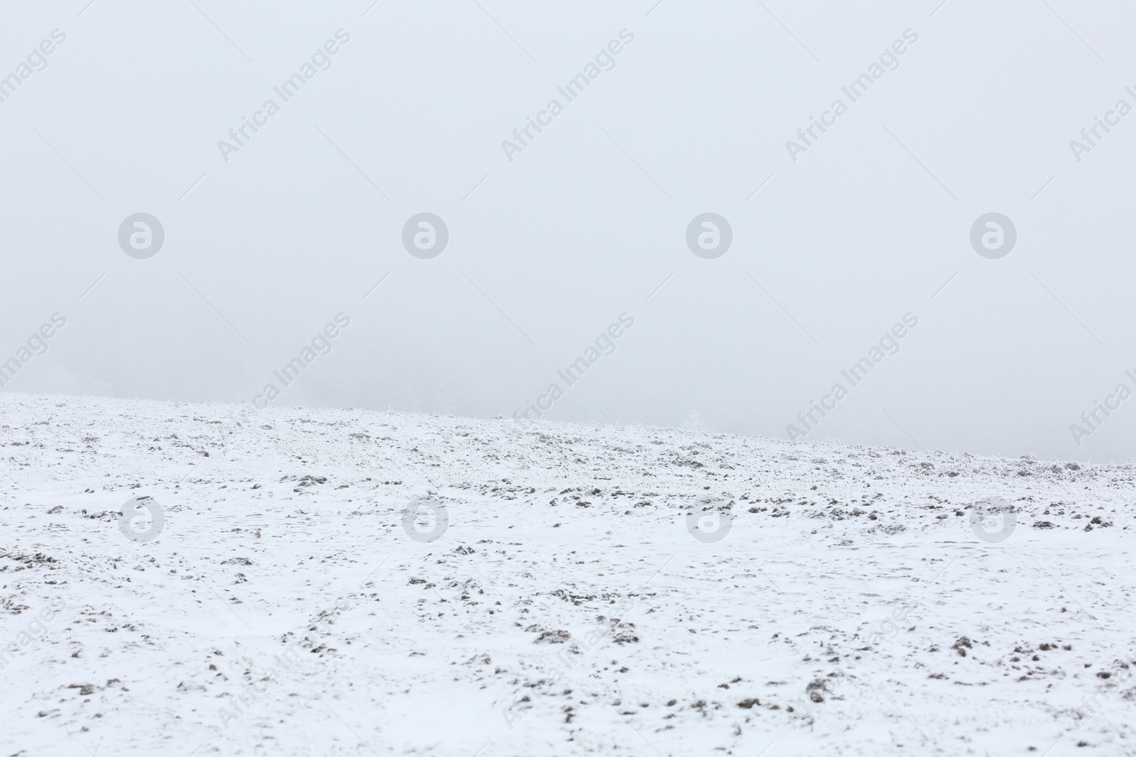 Photo of View of snowy hill on winter day