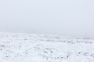 View of snowy hill on winter day