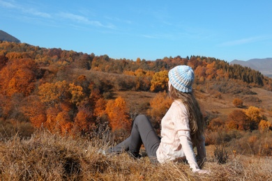 Photo of Female traveler viewing peaceful mountain landscape