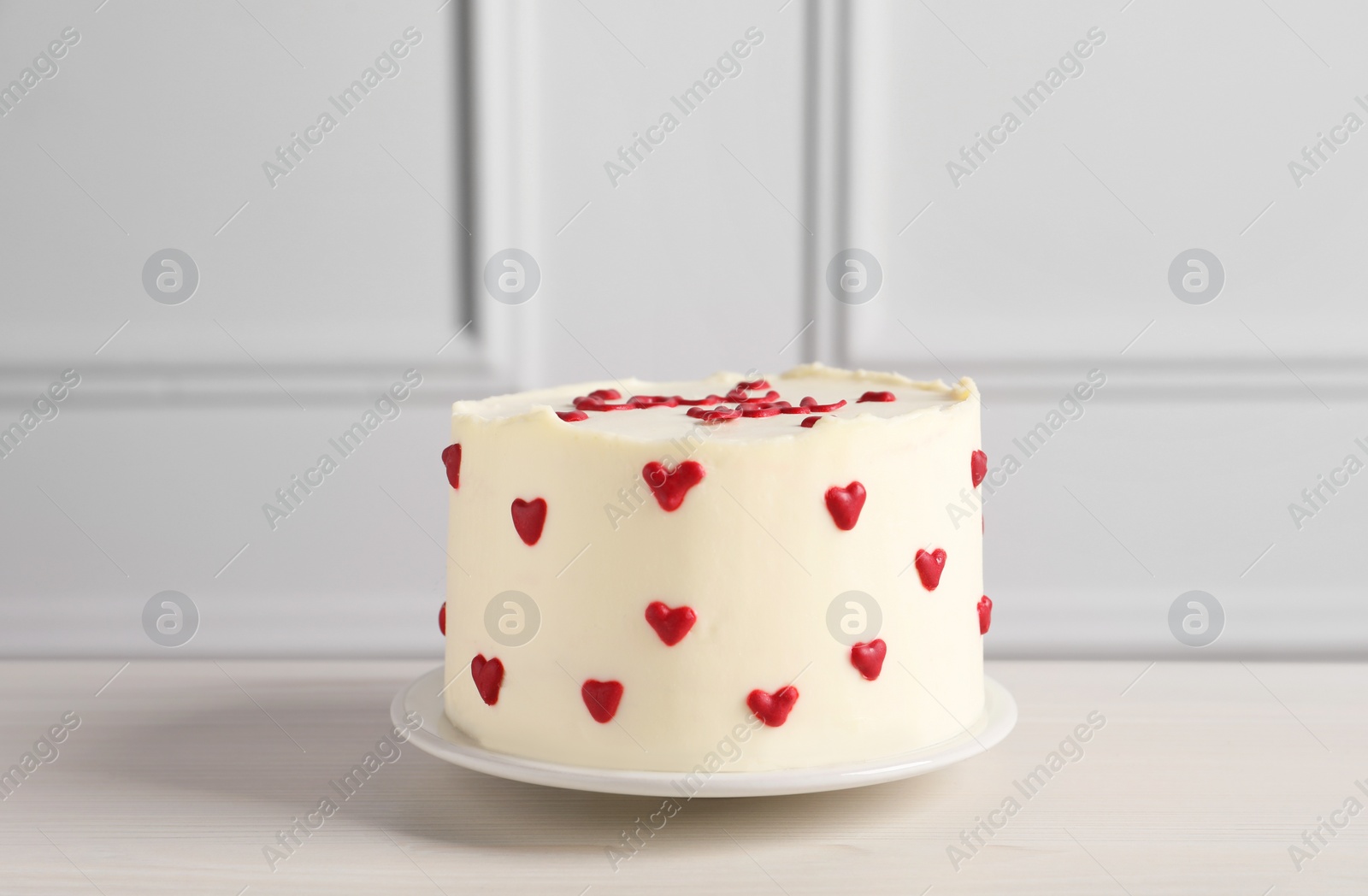 Photo of Bento cake with red hearts on white wooden table. St. Valentine's day surprise