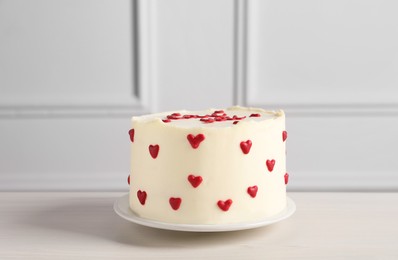 Photo of Bento cake with red hearts on white wooden table. St. Valentine's day surprise