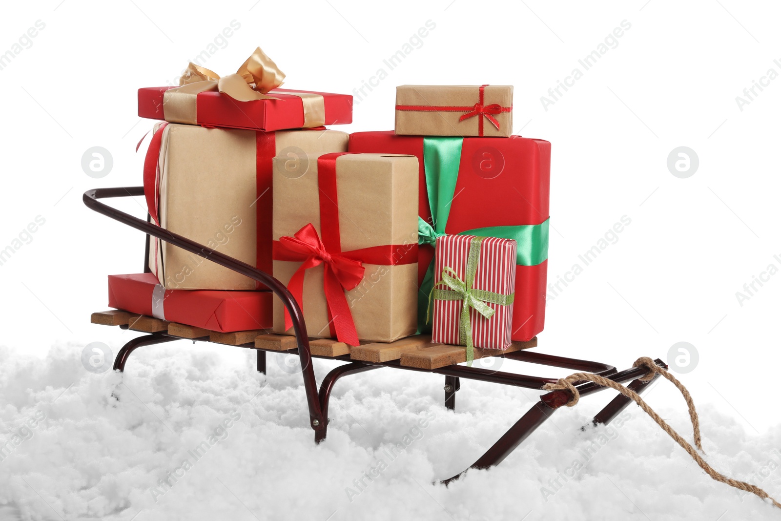 Photo of Sleigh with Christmas gift boxes and artificial snow on white background