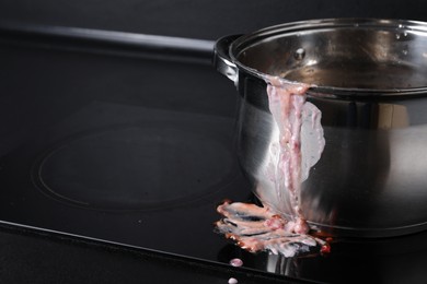 Photo of Dirty pot on cooktop in kitchen, closeup. Space for text