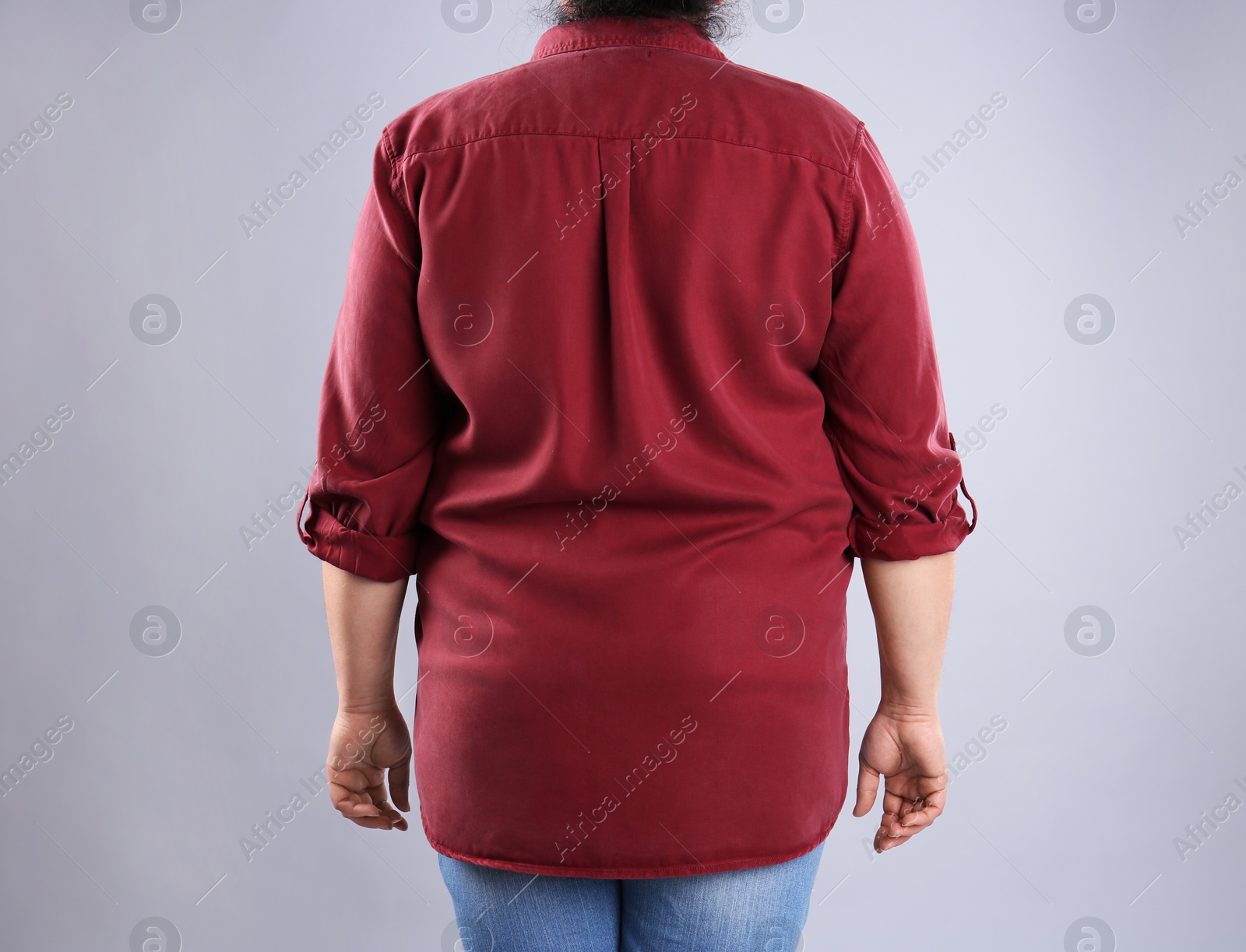 Photo of Fat woman on grey background, closeup. Weight loss