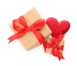 Photo of Beautiful gift boxes and red heart on white background, top view. Valentine's day celebration