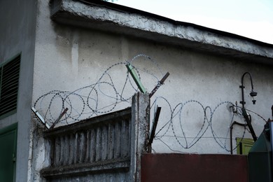 Photo of Metal barbed wire near private property outdoors
