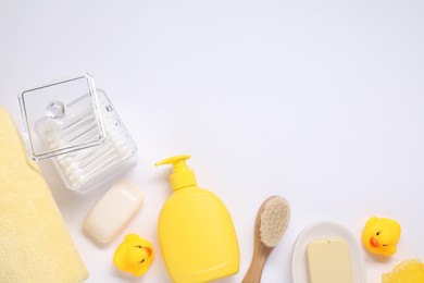 Different baby bath accessories and cosmetic products on white background, flat lay. Space for text