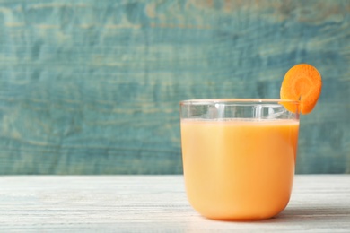 Glass with delicious detox smoothie on table