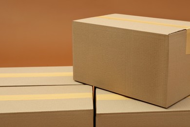 Photo of Group of cardboard boxes on brown background
