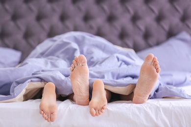 Photo of Young couple in bed at home, closeup