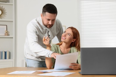 Photo of Couple doing taxes at table in room