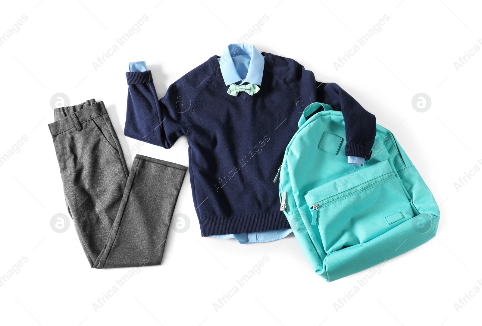 Photo of Stylish school uniform for boy and backpack on white background, top view