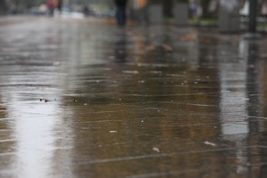 Photo of Wet pavement on city street after rain