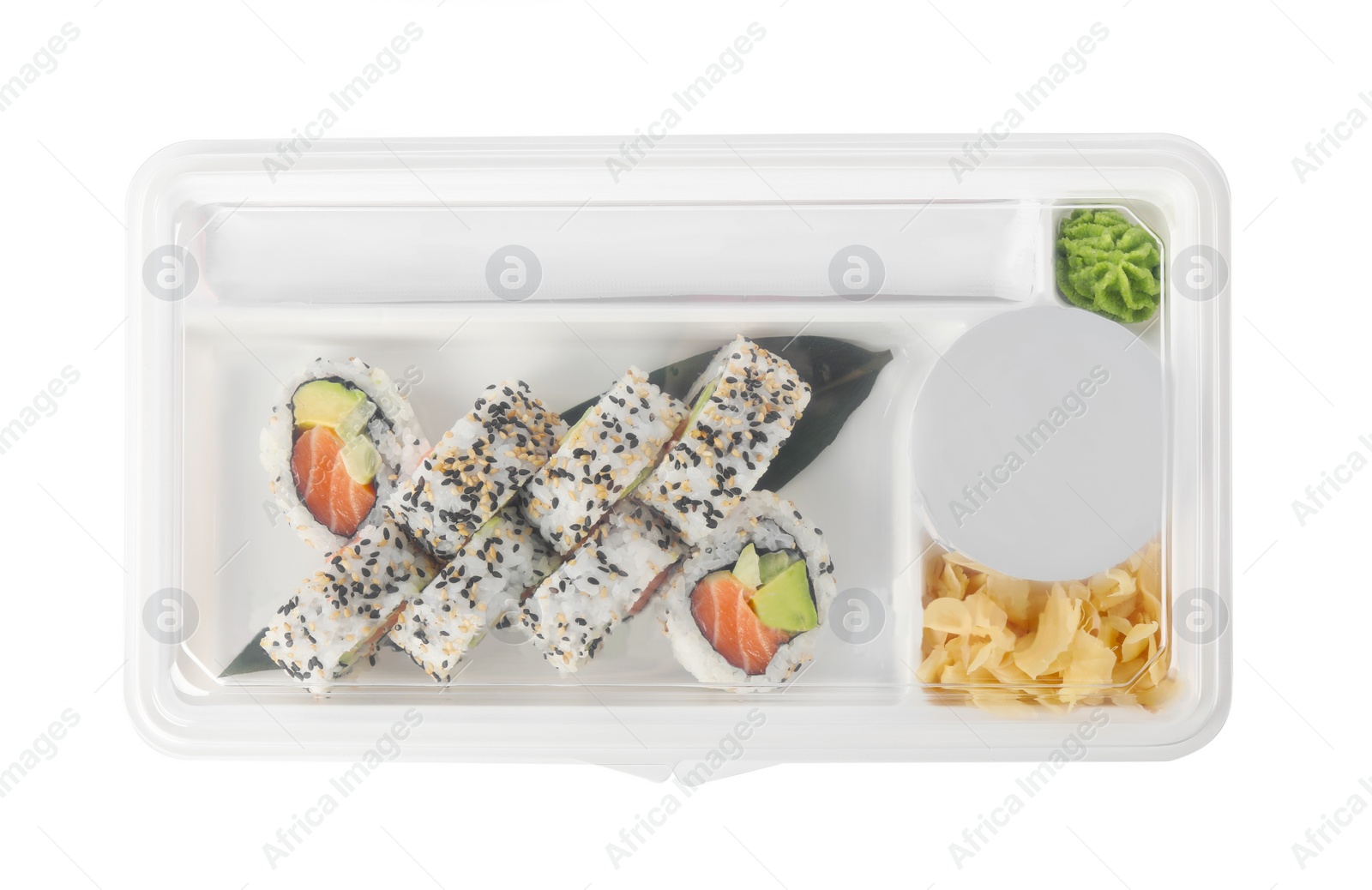 Photo of Food delivery. Delicious sushi rolls with soy sauce, ginger, wasabi and chopsticks in plastic container isolated on white, top view