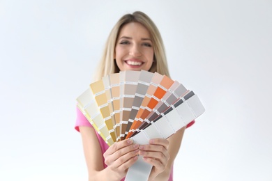 Photo of Young woman with color palette on white background