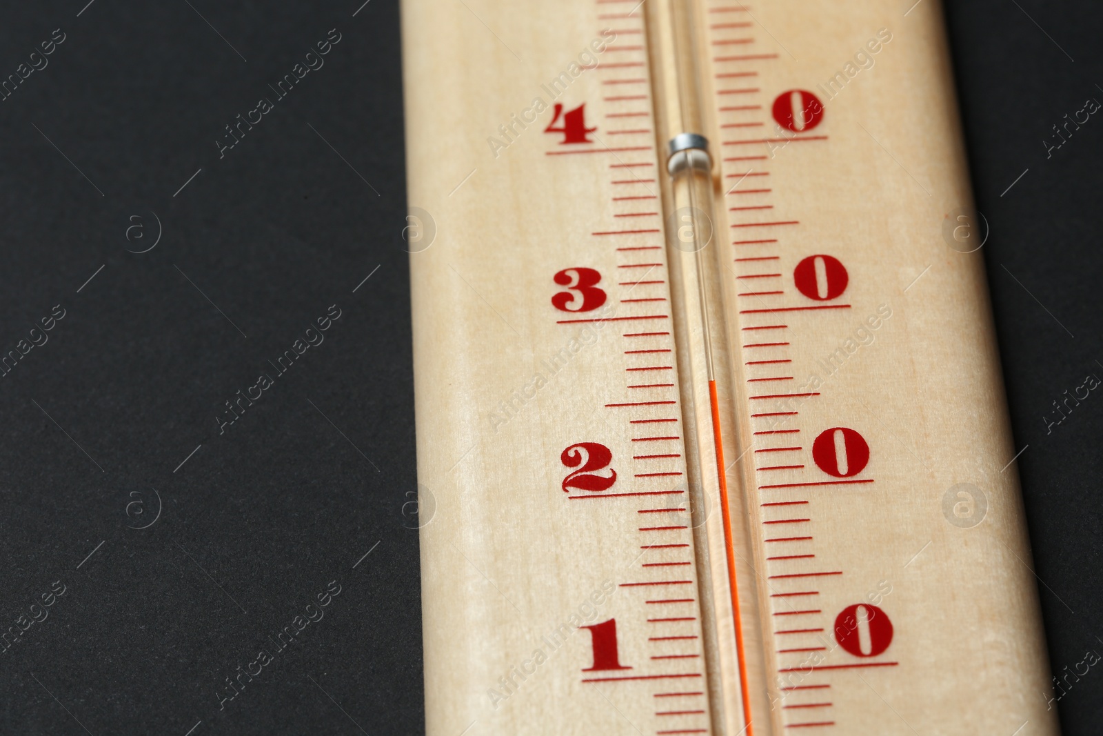 Photo of Weather thermometer on dark background, closeup view