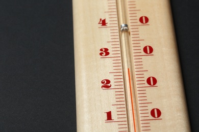 Photo of Weather thermometer on dark background, closeup view