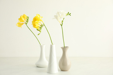 Beautiful freesia flowers on white marble table