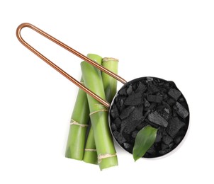 Photo of Fresh bamboo and charcoal on white background, top view