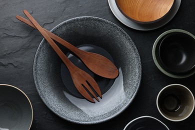 Photo of Set of clean tableware on black table, flat lay