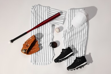 Photo of Flat lay composition with baseball uniform on white background