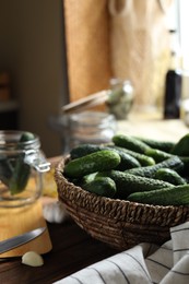 Photo of Fresh cucumbers and other ingredients on wooden table, closeup. Pickling vegetables