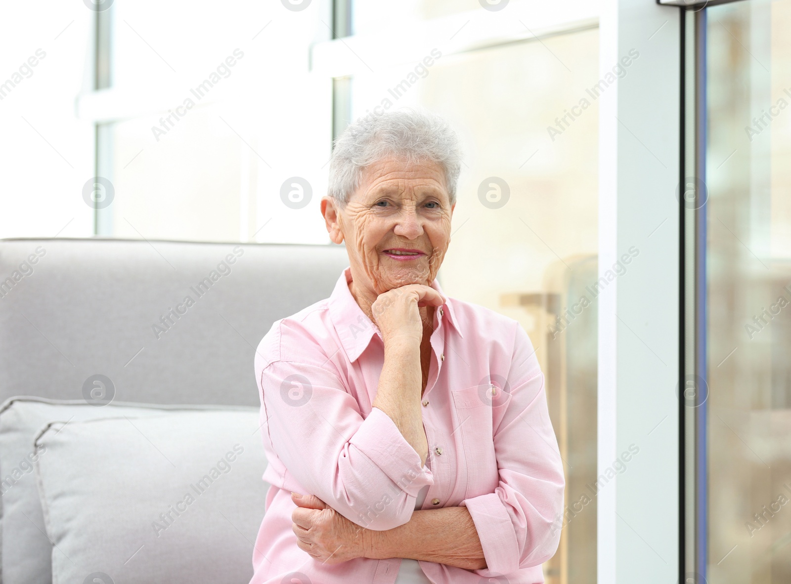 Photo of Portrait of beautiful grandmother in living room