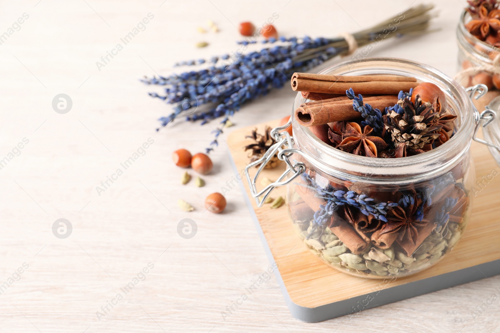 Photo of Aroma potpourri with different spices on white wooden table, space for text