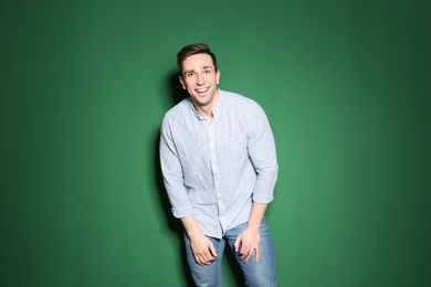 Portrait of handsome man posing on color background