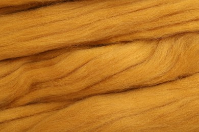 Photo of Orange felting wool as background, closeup view