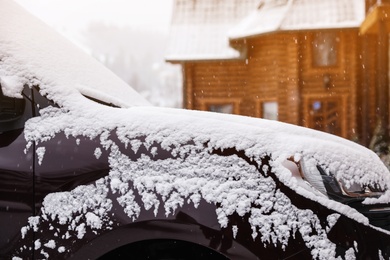 Car covered with snow after storm outdoors on beautiful winter day, closeup