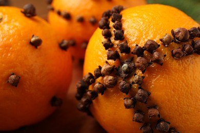 Pomander balls made of tangerines with cloves, closeup