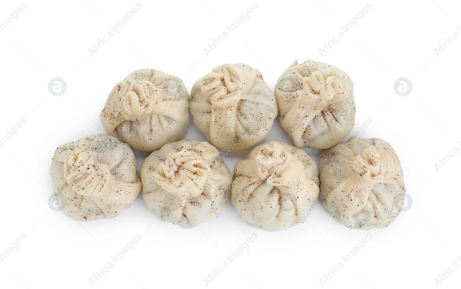 Photo of Many tasty khinkali (dumplings) and spices isolated on white, top view. Georgian cuisine