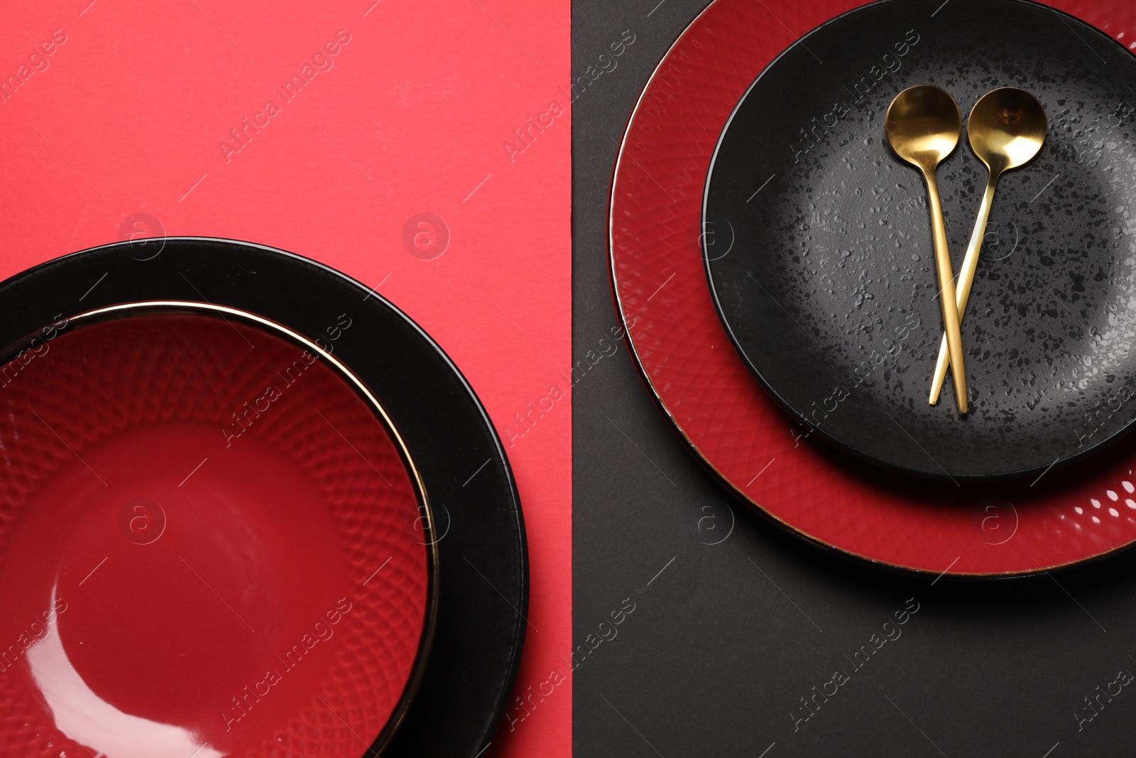 Photo of Stylish table setting with plates and spoons on color background, top view