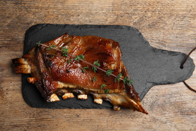 Photo of Delicious roasted ribs served on wooden table, top view